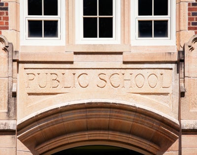 Image of "Public school" engraved on a building's exterior