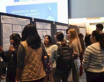 students presenting at research day