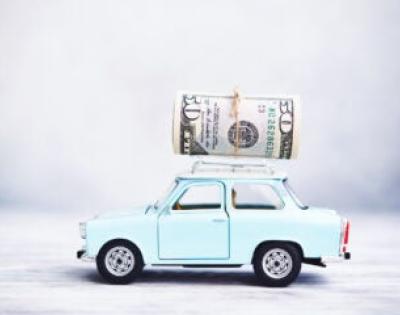 Money on top of small blue car