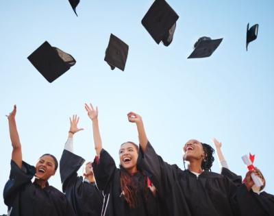 Graduates throwing hats in the air