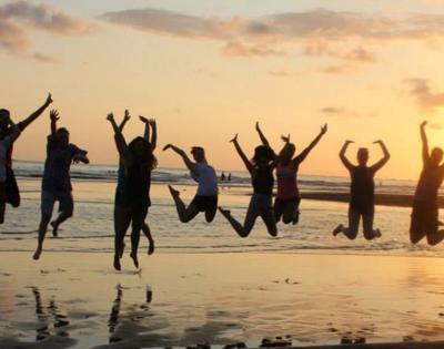 students-jumping-beach
