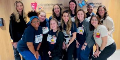 Cristin Coleman and other founding members of UH Rainbow Babies & Children’s Hospital's pediatric cardiac intensive care unit pose for a group photo.  