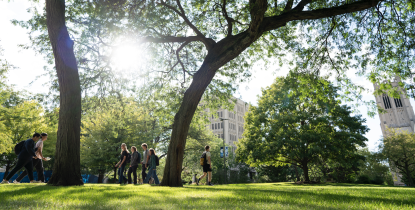 Students walking on campus on a sunny day