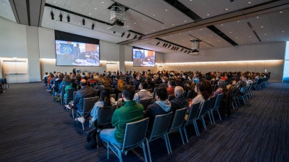 Audience members sit in Tinkham Veale University Center's Kelvin & Eleanor Smith Foundation Grand Ballroom at fall open house.  