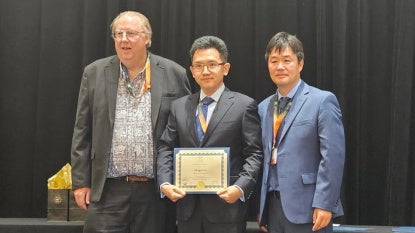 Chengyu Li takes a gropo photo after receiving the Fluids Engineering Division Summer Meeting Rising Star (FEDSM) Award.