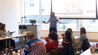 A professor talks to students during a class