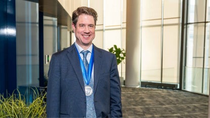 Andrew Pieper posing with the Case Medal around his neck