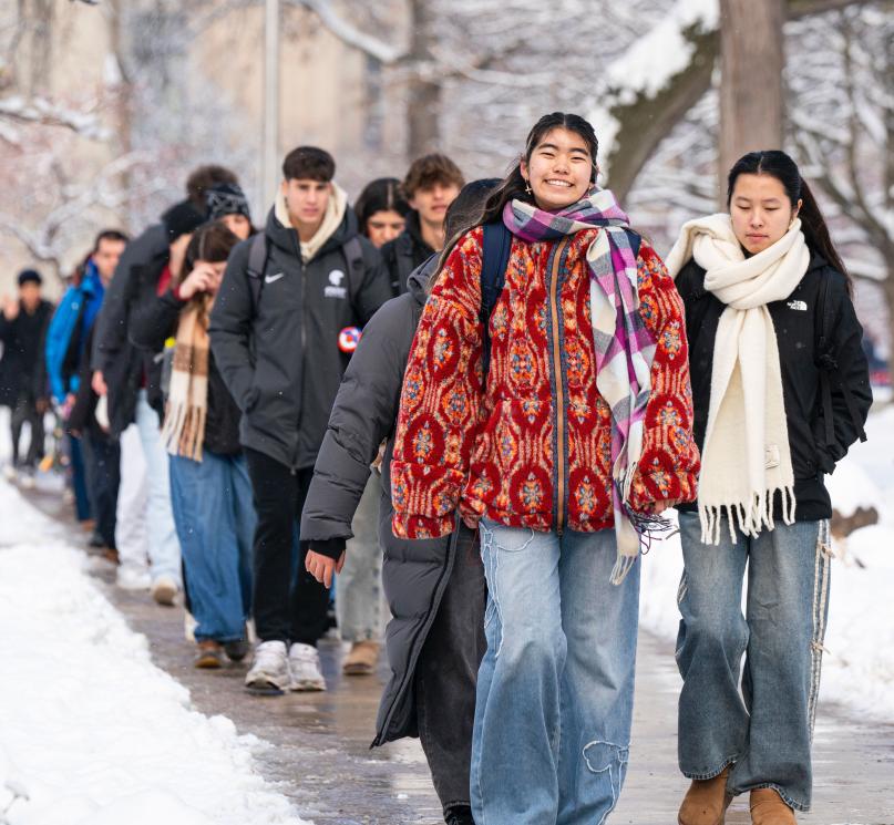 A large group of students walking through Case Quad.