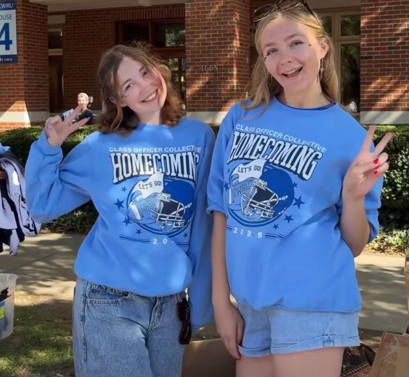 Two students pose in the 2025 homecoming merch.
