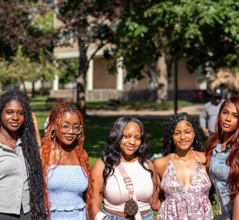A group of Black students posing near CWRU dorms.