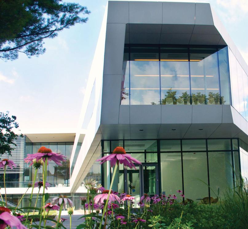 Tinkham Veale University Center with pink flowers in the foreground.