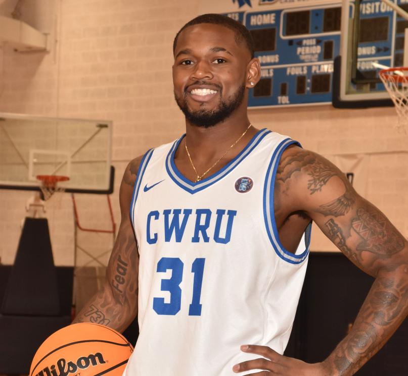 CWRU student Ethan Edwards poses with a basketball in Horsburgh Gymnasium.