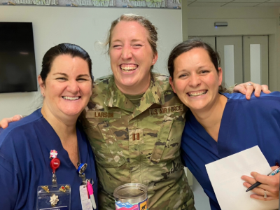 Abby Henkel, RN in medical scrubs with colleagues at the hospital
