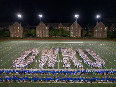 Photo taken from above as the Class of 2029 spells out CWRU on DiSanto Field during Discover Week 