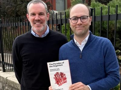 Co-editors J. Arvid Ågren and Manus M. Patten pose with their book, The Paradox of the Organism: Adaptation and Internal Conflict. 