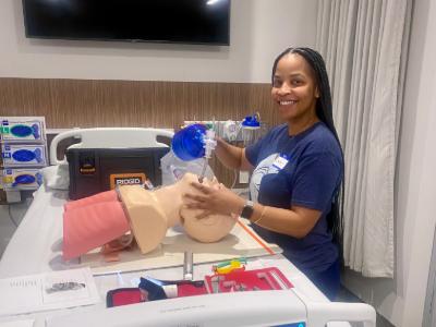 CRNA student Dawn Lynn practices nursing procedures on a teaching mannequin. 