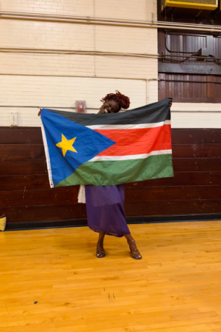 Jube Augustino with flag of South Sudan