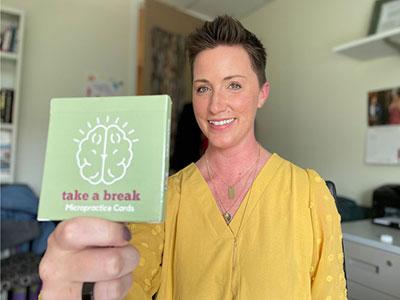 Photo of Jenny King holding a pack of her "Take a Break" cards