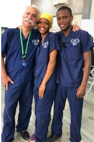 Siegel posing with two healthcare providers on Mercy Ship