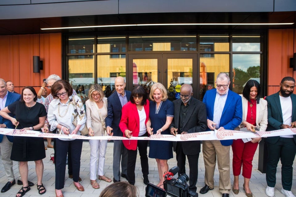 A group gathers to cut the ribbon on the new MidTown Collaboration Center