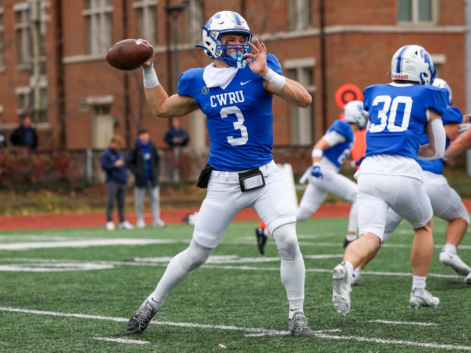 Aaron Filips throwing a pass as quarterback on a football field