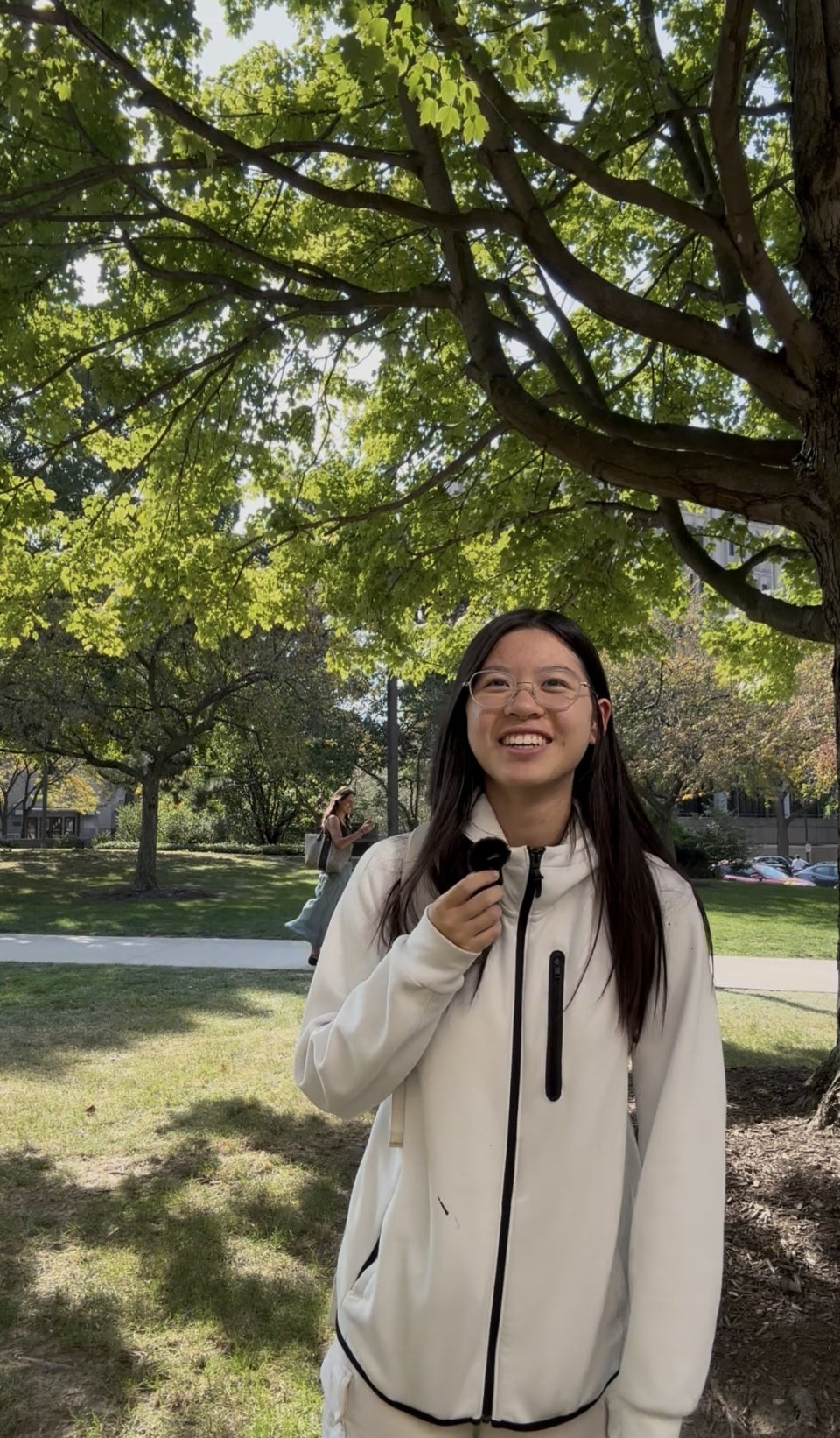 Second-year student Emma Lin standing on campus on a sunny day