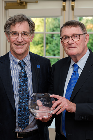 Timothy O’Brien posing with his Distinguished Service Award