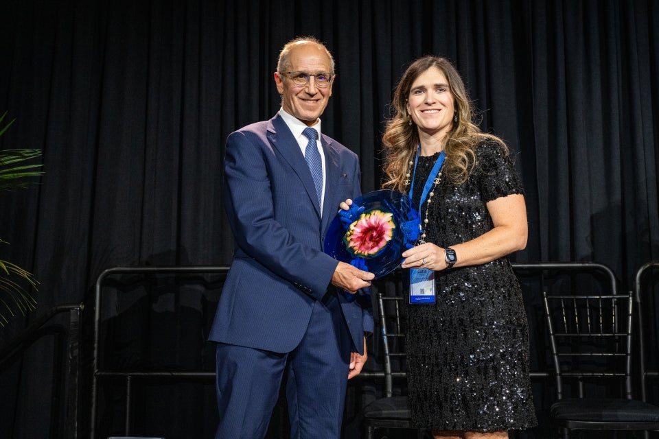 Hicks accepting award from Dean Gerson