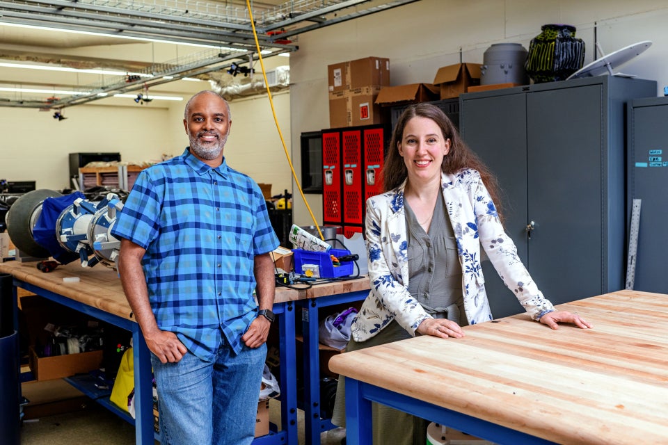 Two faculty members standing in their shared lab space.