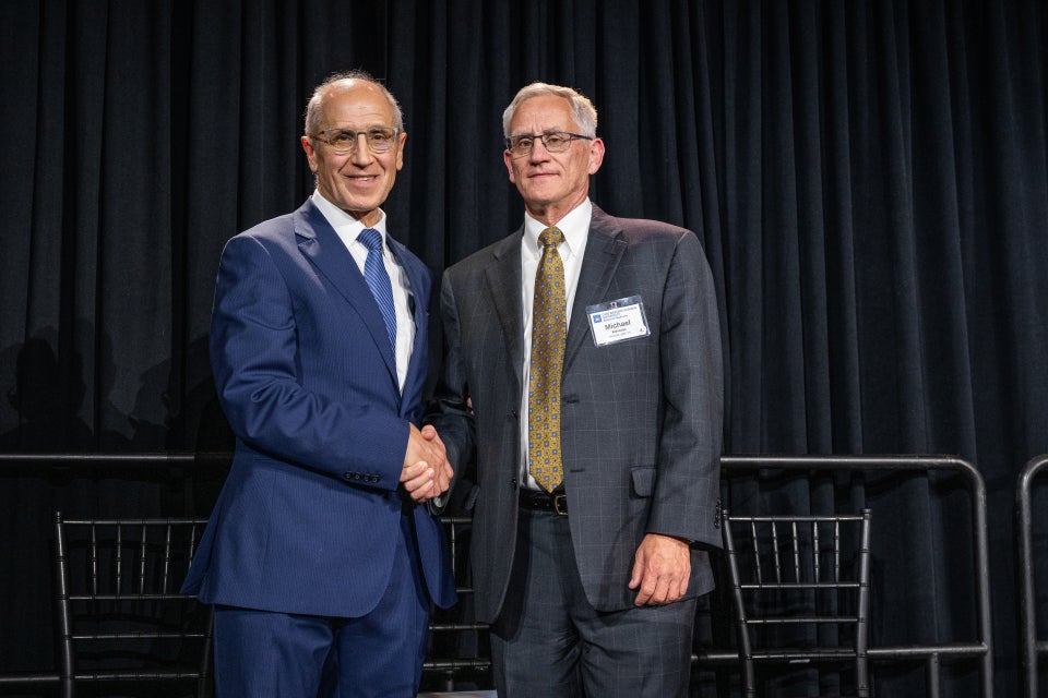 Konstan shaking hands with Dean Gerson