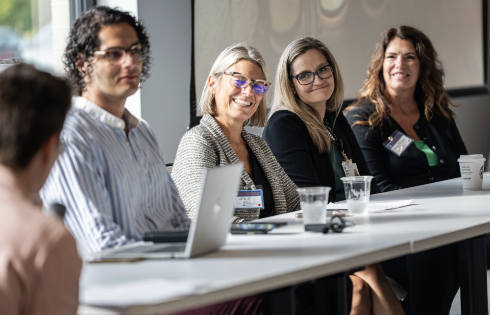 People sitting at a table during a session at the reproductive symposium