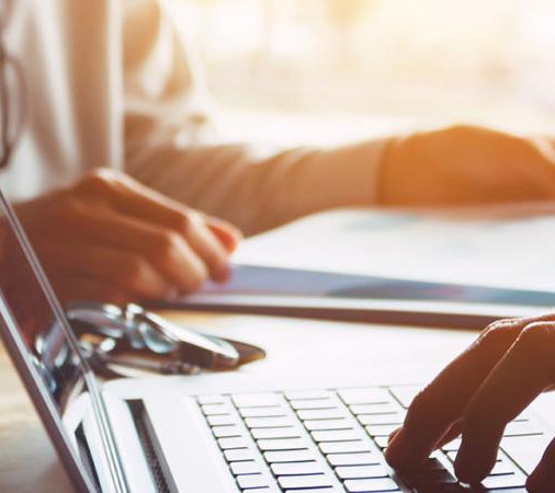 fingers typing on a keyboard