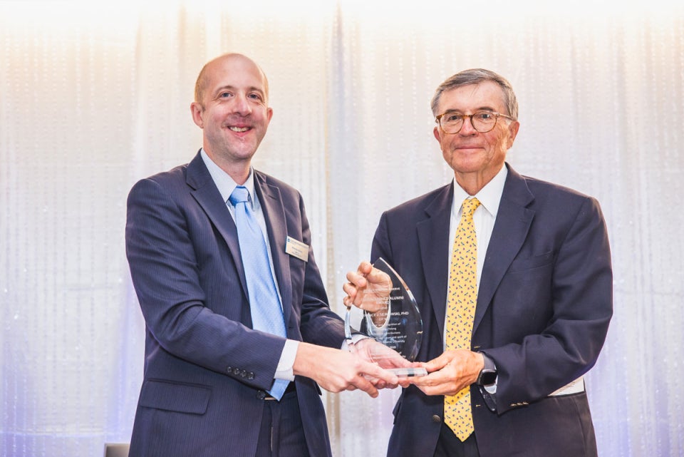 CWRU alumni Nicholas Zalany and Terrence Sejnowski pose with an award