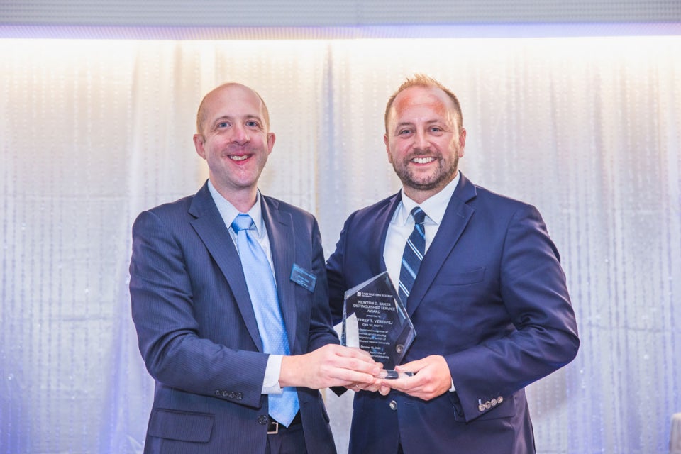 Case Western Reserve University alumni Nicholas Zalany and Jeffrey Verespej pose with an alumni award