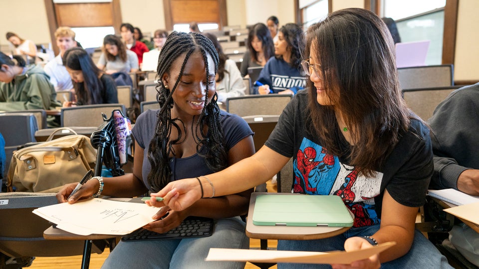 Photo of two students interacting in a classroom