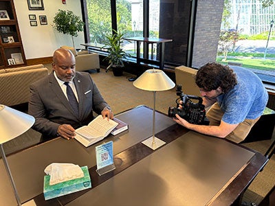Photo of Atiba Ellis sitting down for an interview