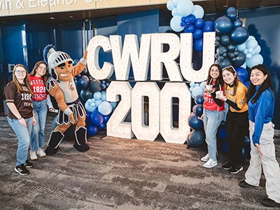 Photo of students gathered at the bicentennial kickoff with a CWRU 200 sign