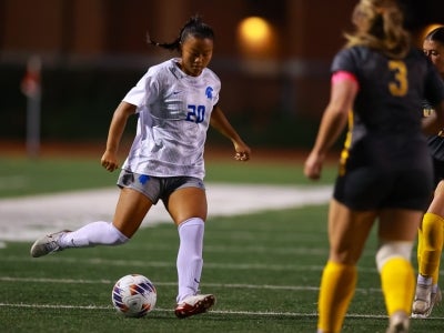 Jamie Goldfarb kicks a soccer ball during a game. 