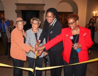 Faye Gary, EdD, May Wykle PhD, Carolyn Harper Still, PhD, and Regennia Williams, PhD, cut a yellow ribbon at the WRHS nursing exhibit. 