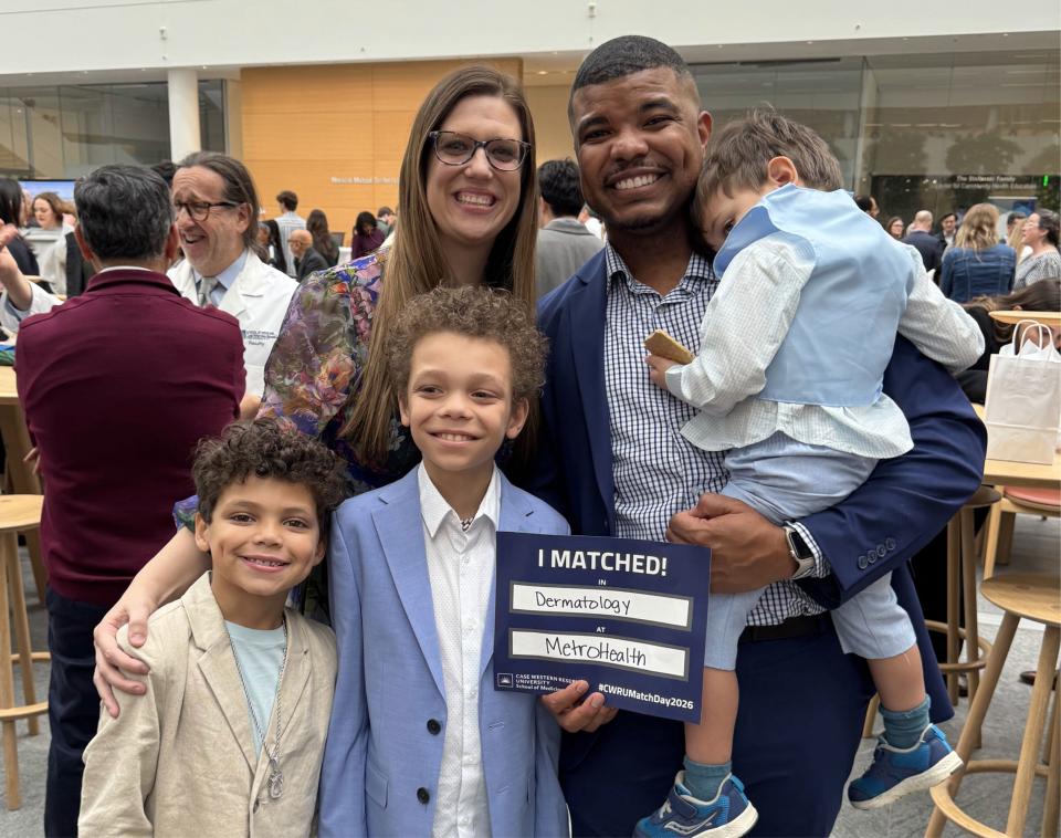 Brock posing with his wife and children at Match Day