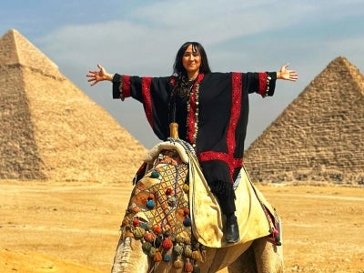 Sarah Shendy poses with the Egyptian pyramids in the background. 