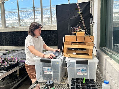Photo of Miranda Shetzer working with a pigment device