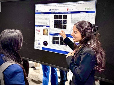 Photo of Reshma Rajesh presenting her research poster at NCUR