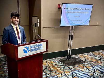 Yashwant Pantra stands at the podium during his NCUR presentation