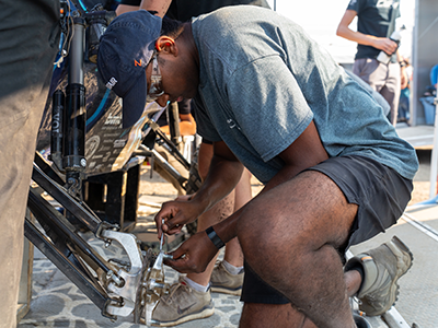 Photo of Auston Govender working on a baja car