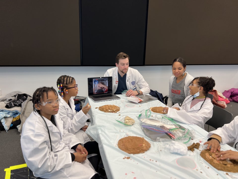 Brian Bangs talking with children during his pediatric work