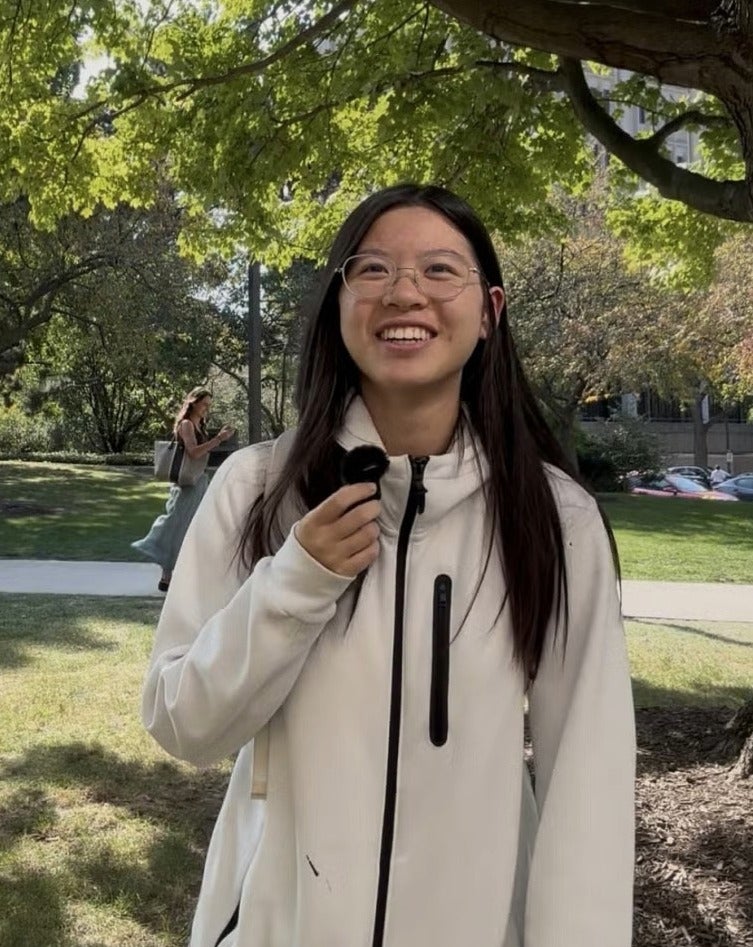 Second-year student Emma Lin standing on campus on a sunny day