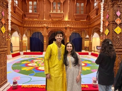 Krish Shah (pictured left) and his partner celebrates Diwali in Chicago, IL in front of a rangoli. Believed to bring good luck, this vibrant Indian floor art form features patterns created by colored powders, rice flour, flower petals and sand. 