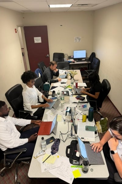 Interns sitting around a table working in a conference room