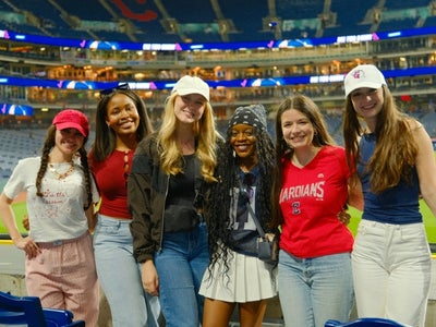 Skyler Kopit (pictured left) attends a Cleveland Guardians game with friends. 